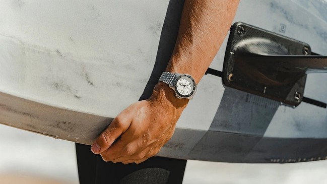 Bremont_SM500_White_Lifestyle with surfboard worn by kite surfer Tom Bridge