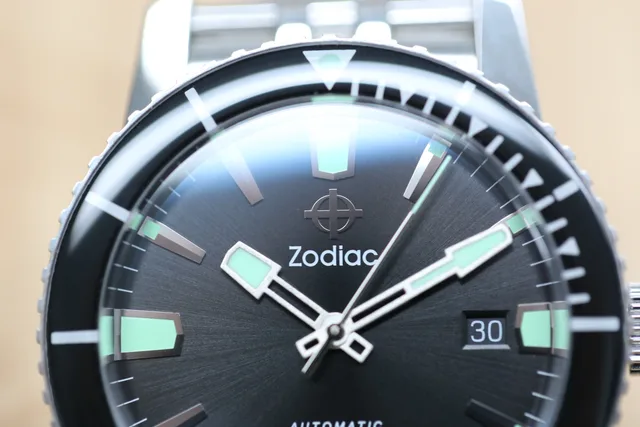There's a sunburst detailing on the black dial.
